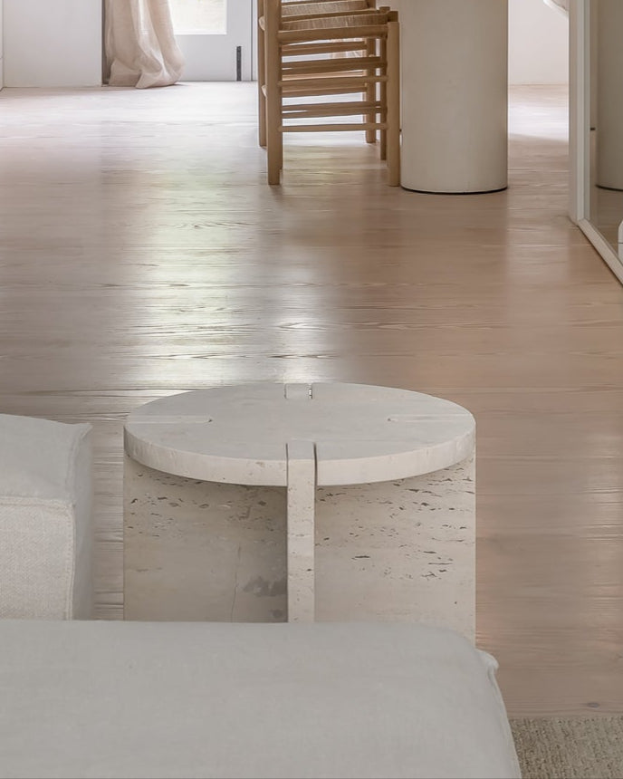 Modern interior design of a living room with a dining area in the background.