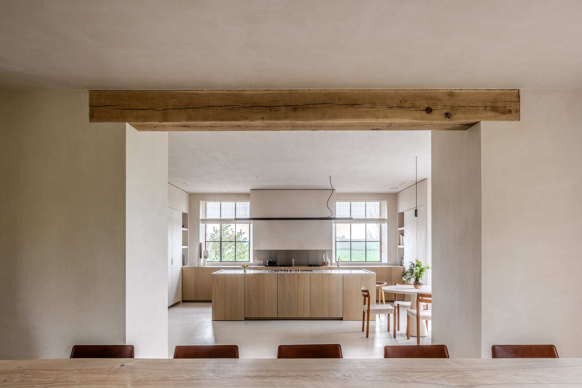 Modern kitchen with wooden beams and large windows