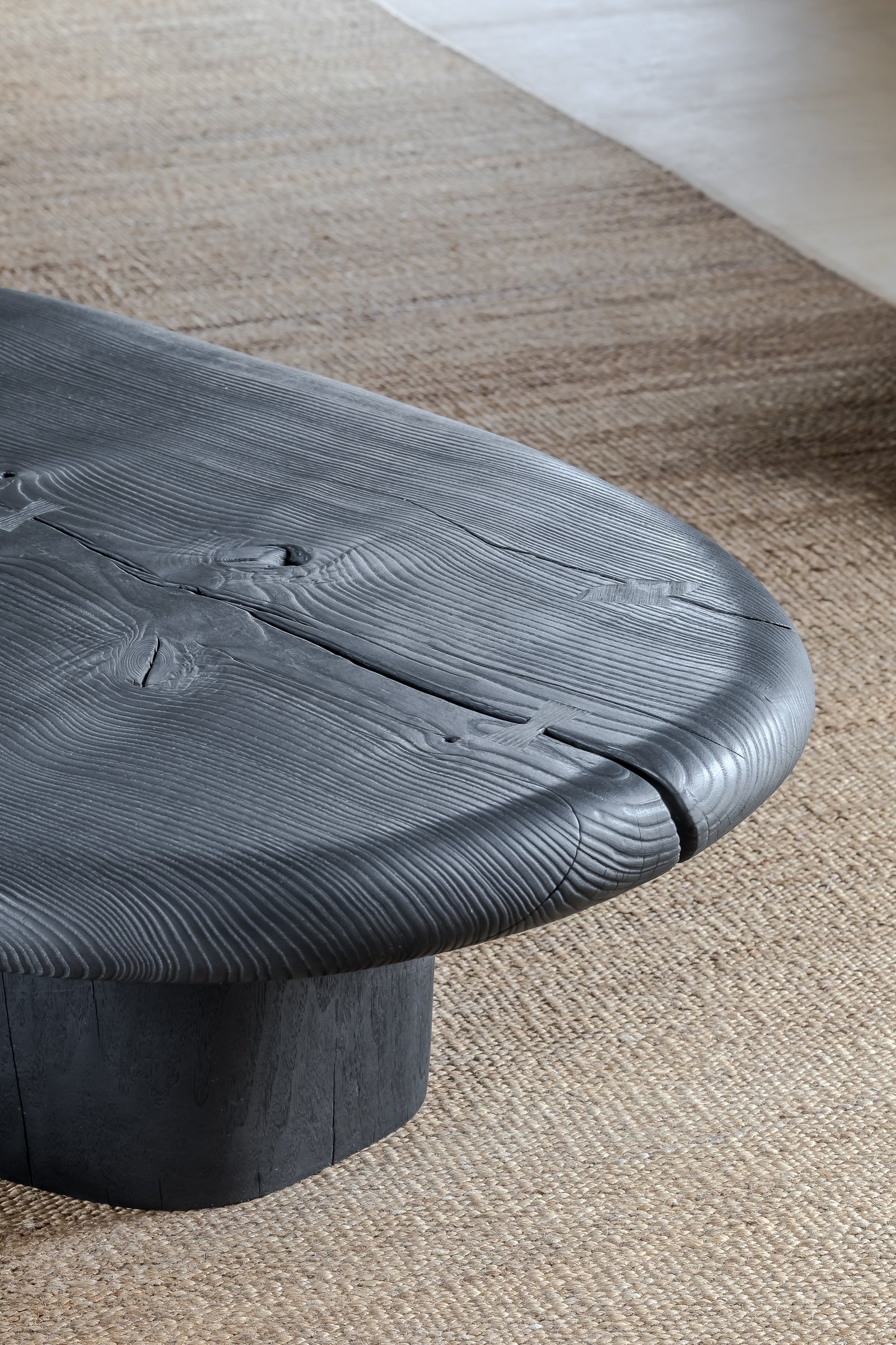 Close-up of a textured black table on a carpeted floor